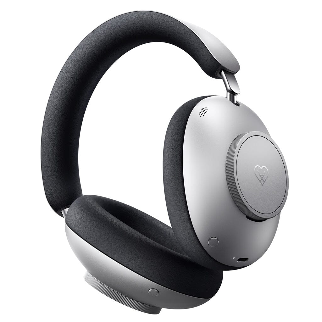 Introducing the Loewe Leo Wireless Headphones by Loewe—sleek, modern over-ear headphones featuring a stylish silver and black design with cushioned ear pads and a distinct small heart symbol on the outer ear cup. Enjoy a truly immersive listening experience with adaptive noise cancellation and personalized sound in this premium wireless model.