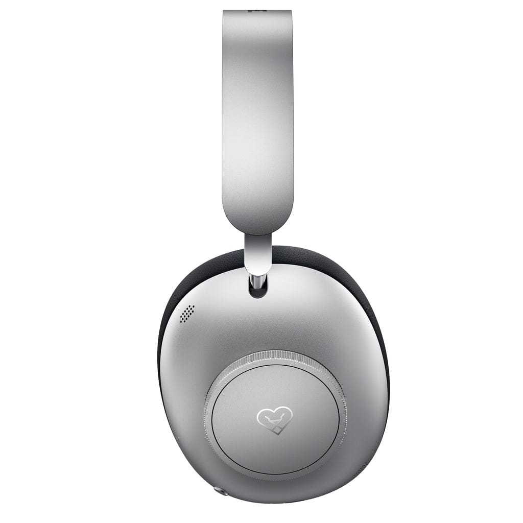 A close-up of the Loewe Leo Wireless Headphones in silver, viewed from the side. The earcup displays Loewe’s heart-shaped logo at the center and showcases a minimal, sleek design that highlights its personalized sound experience.