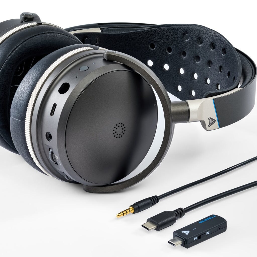 The Audeze Maxwell 2 ANC Wireless Headphones by Audeze, shown in black with an over-ear design and a perforated headband, are displayed on a white surface alongside a USB-C cable, 3.5mm audio cable, and USB wireless dongle.