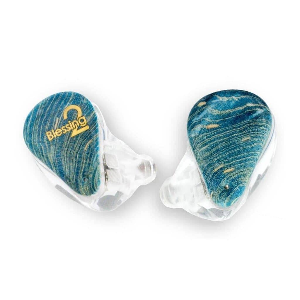 A pair of Moondrop Blessing 2 In-Ear Headphones - Open Box, featuring clear shells, blue wood-textured faceplates, and a gold Blessing 2 logo on one earpiece.