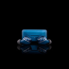 The Noble Audio Osprey Wireless In-Ear Headphones by Noble Audio, in blue with silicone tips, are displayed on a glossy black surface with their matching charging case. Featuring a hybrid driver design, they offer enhanced sound quality. Preview