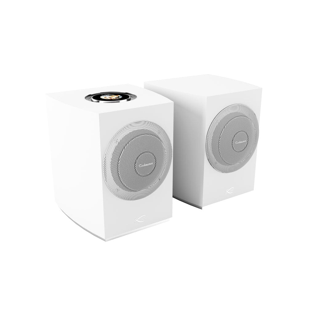 Two Cabasse Rialto Wireless Powered Bookshelf Speakers in modern white with circular grilles and minimalistic design are side by side on a white background. The left speaker features a small black and gold detail on top.
