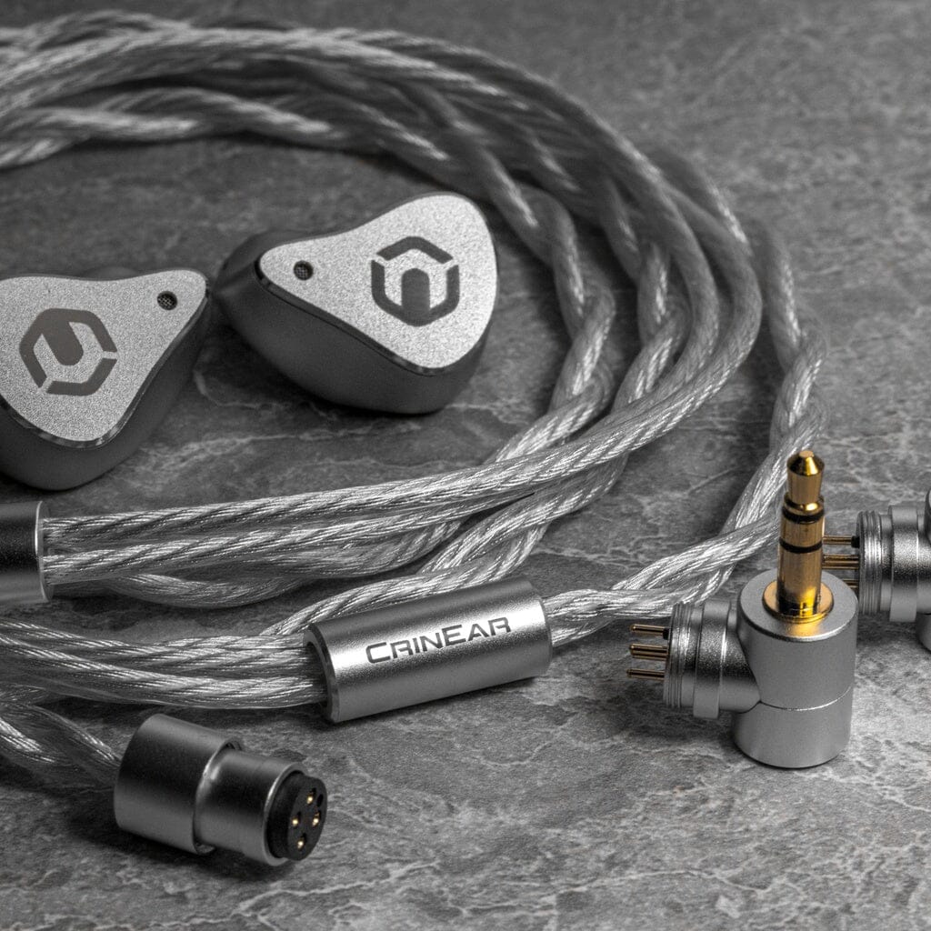 CrinEar Reference In-Ear Headphones in silver with matching braided cables feature detachable connectors, a gold-plated 3.5mm jack, and "CrinEar" branding on the metal cable cinch, all displayed on a gray textured surface.