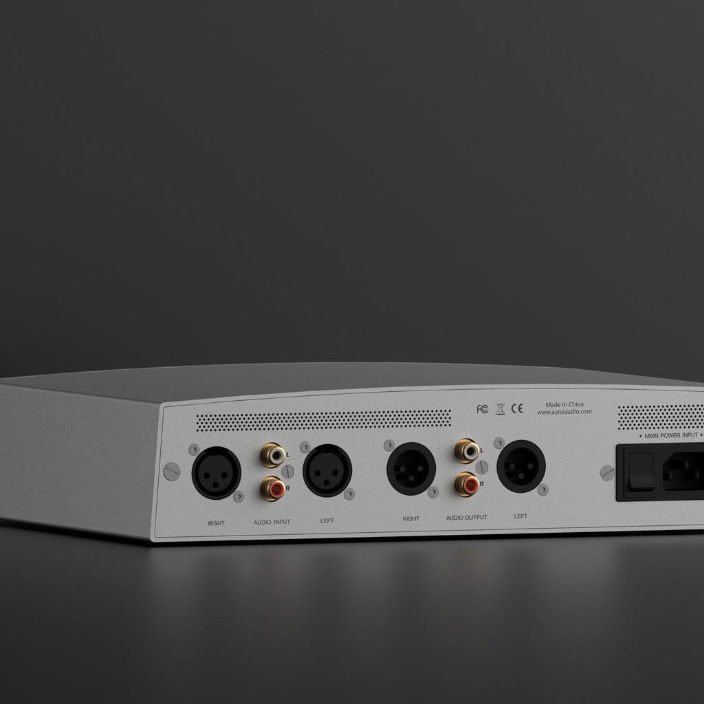 The Aune Audio S17 Pro EVO Headphone Amplifier by Aune Audio is displayed against a dark background. This silver device features multiple input and output ports, including XLR and RCA connectors, with clearly labeled right and left audio input and output channels. As a fully balanced Class A headphone amplifier, it combines high-end performance with intuitive design.