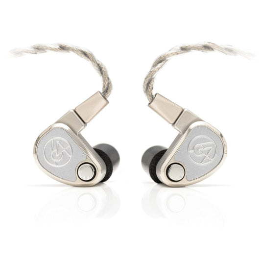 A pair of 64 Audio TWELVE Ti silver titanium in-ear headphones with a triangular shape, braided cables, and black ear tips are placed side by side on a white background.