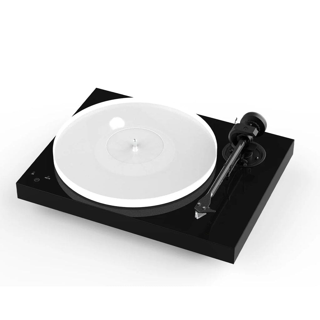 The Pro-Ject Audio Systems X1 B True Balanced Turntable (Open Box - Clearance) is a modern black belt-drive turntable with a sleek design, showcasing a clear platter and carbon-aluminum tonearm, as seen from a high-angle perspective.