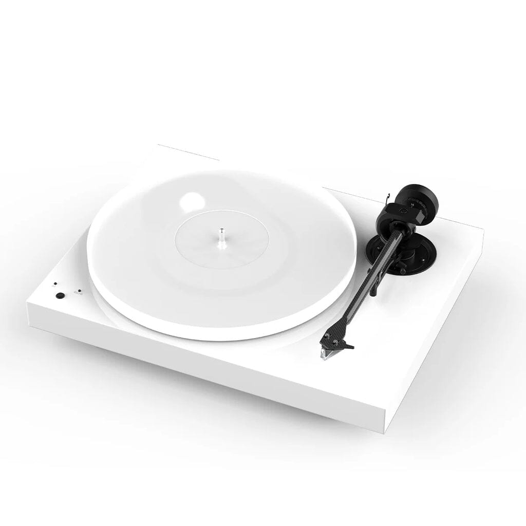 The Pro-Ject Audio Systems X1 B True Balanced Turntable (Open Box - Clearance) is a modern white belt-drive turntable with a transparent platter and a sleek black carbon-aluminum tonearm, displayed against a white background. Its minimalist design features True Balanced phono connectivity and intuitive controls on the left side.