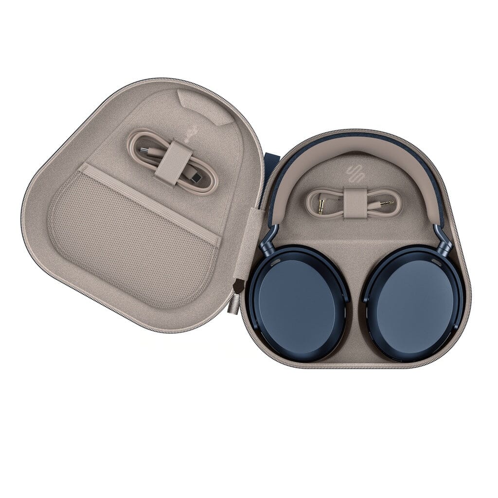 A pair of Sennheiser Momentum 5 Wireless Headphones are neatly placed inside an open light gray carrying case, with a mesh pocket holding the charging cable.