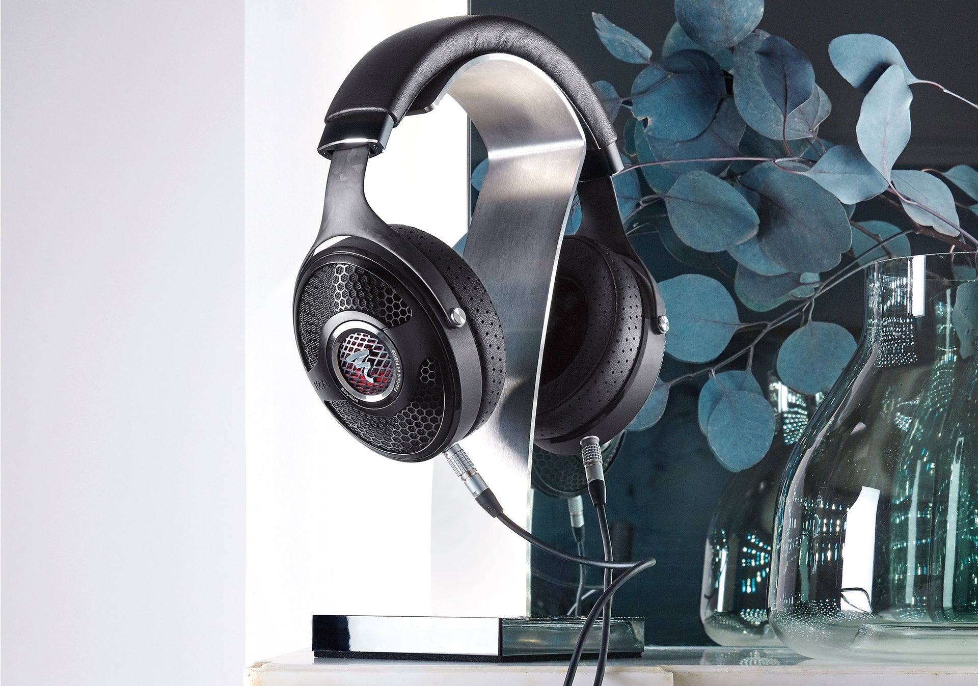 Utopia headphones on stand with plant in background